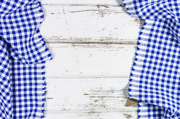 Blue folded tablecloth over wooden table