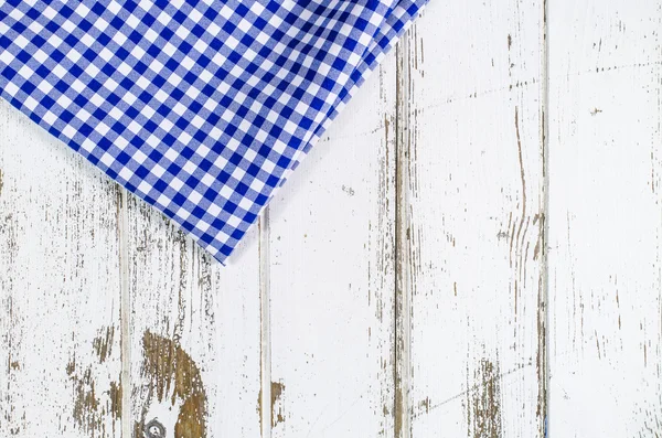 Blue tablecloth over wooden table — Stock Photo, Image