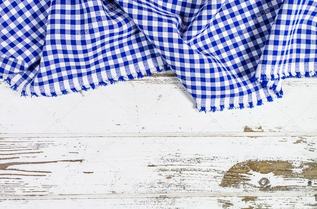 Blue folded tablecloth over wooden table