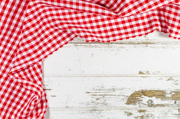 Red folded tablecloth over wooden table — Stock Photo, Image