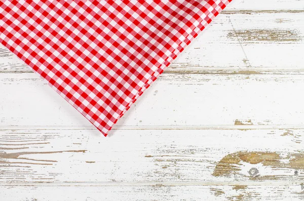 Red tablecloth over wooden table — Stock Photo, Image