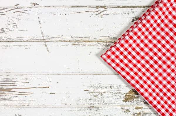 Red tablecloth over wooden table — Stock Photo, Image