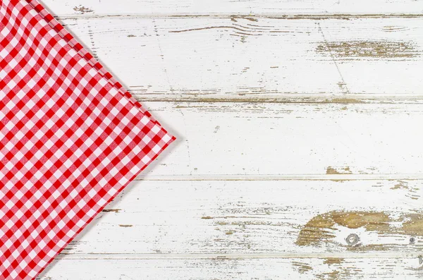 Red tablecloth over wooden table — Stock Photo, Image