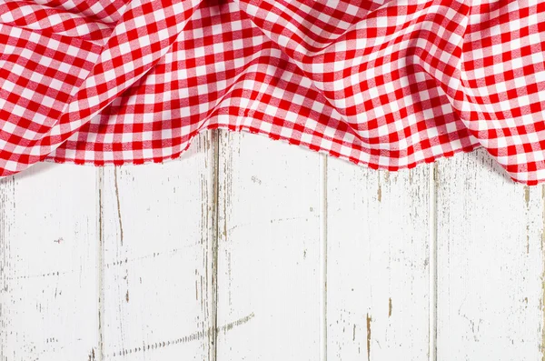 Red folded tablecloth over wooden table — Stock Photo, Image