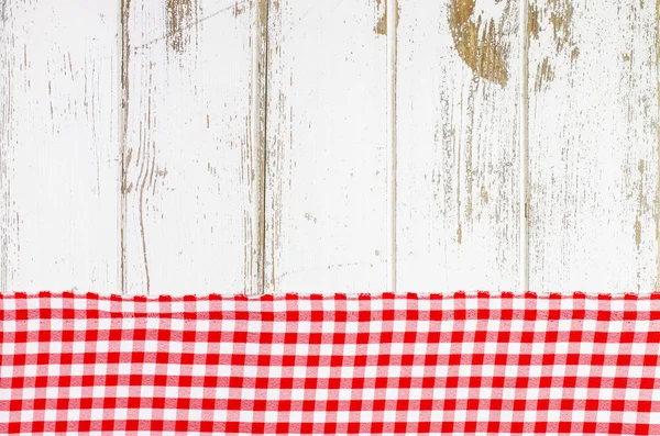 Red tablecloth over wooden table — Stock Photo, Image