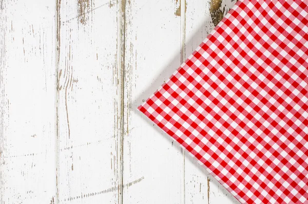 Red tablecloth over wooden table — Stock Photo, Image