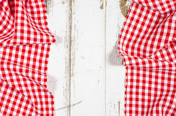 Red folded tablecloth over wooden table — Stock Photo, Image