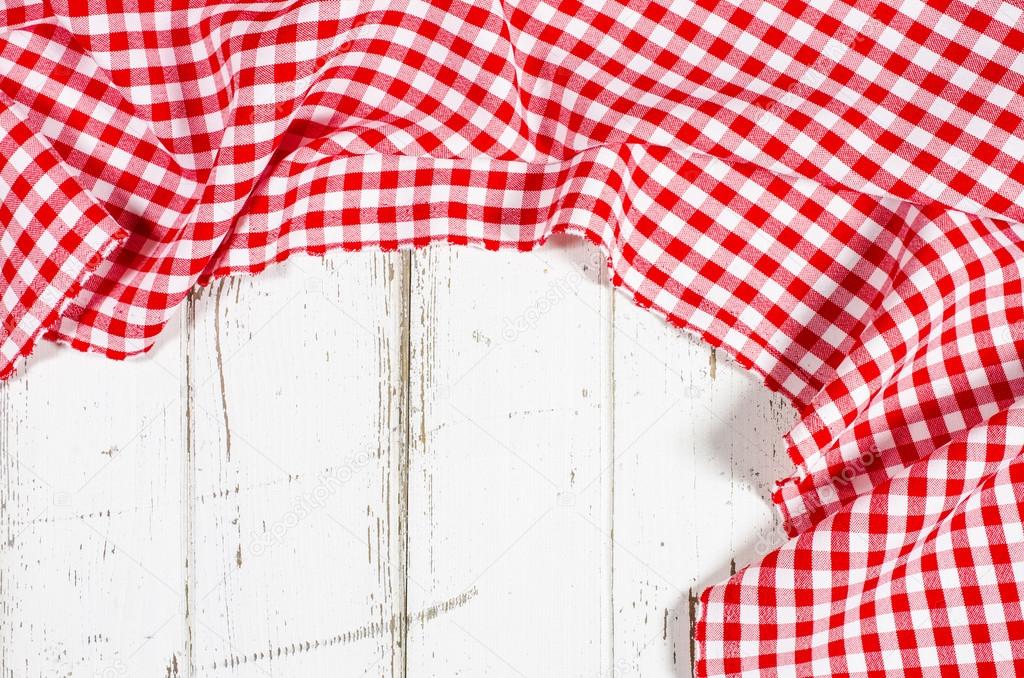 Red folded tablecloth over wooden table