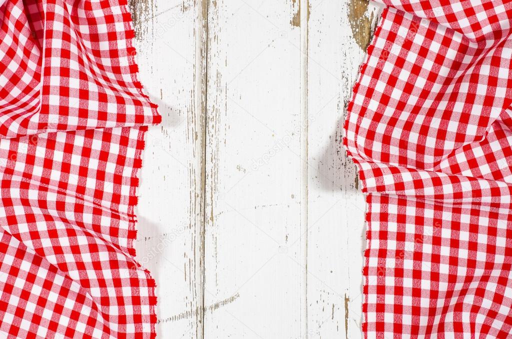 Red folded tablecloth over wooden table