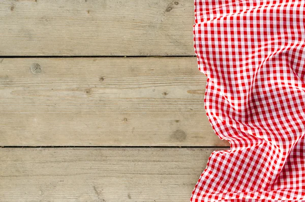 Red folded tablecloth over wooden table — Stock Photo, Image