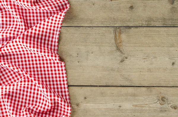 Red folded tablecloth over wooden table — Stock Photo, Image