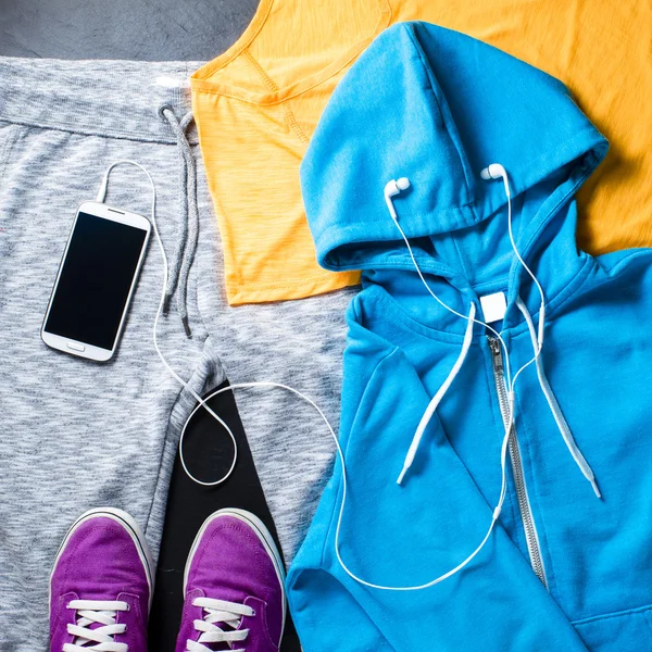 Sport clothes, shoes and mobile phone with headphones