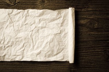 Ahşap masa üzerinde buruşuk kağıt