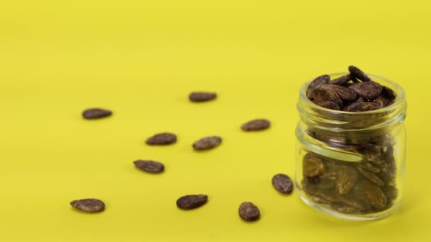 Watermelon Seeds Poured Jar Yellow Background — Stock Video