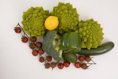 fresh vegetable, romanesco, pepper, zucchini, avocado, cherry tomato and lemon, free space in your text on a isolated background.