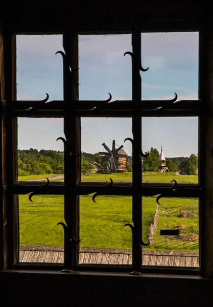 Historic window in the church. Window with forged defense. The window with wrought iron grilles. Country views. — Stock Image Historic window in the church. Window with forged defense. The window with wrought iron grilles. Country views. Stock Picture