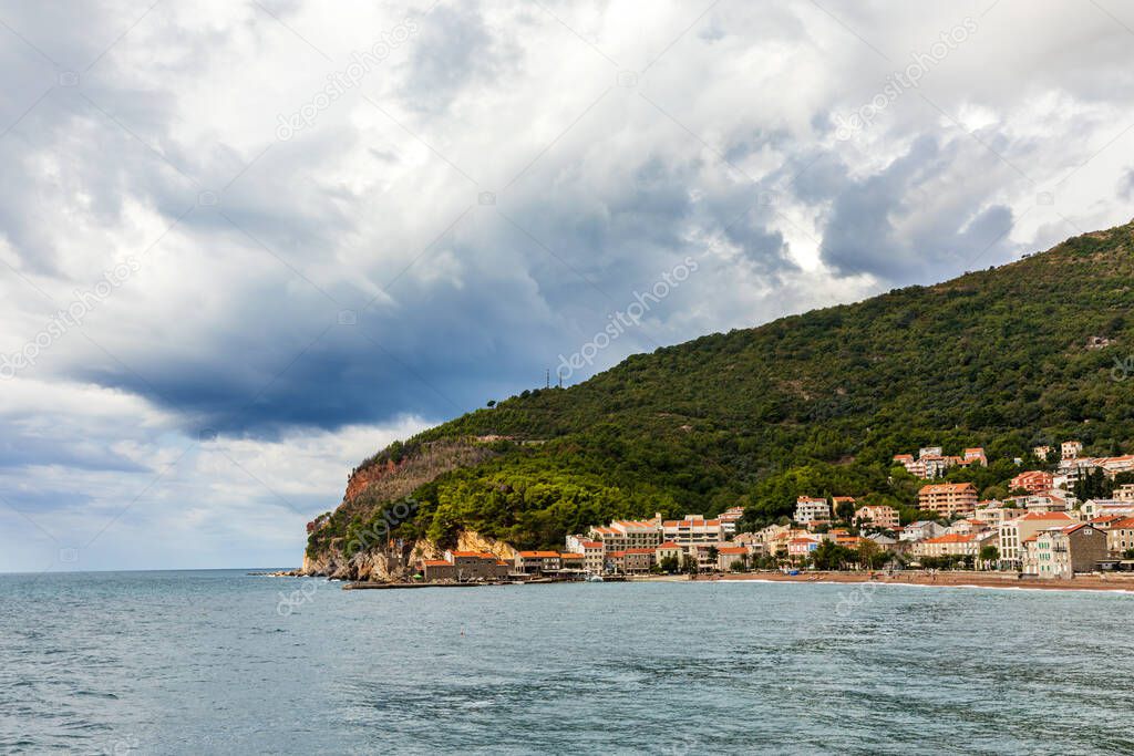 Public beach of Petrovac town with fortress. 