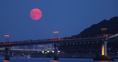 Full Moon is rising over the Pedestrian Bridge with at night in Kyiv city, Ukraine