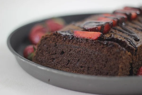 Finger millet chocalate cake. A Healthy Homemade Chocolate cake made with finger millet flour instead of all purpose flour, decorated with a generous drizzle of chocolate sauce and strawberries.