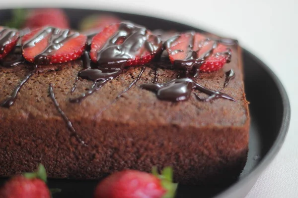 Finger millet chocalate cake. A Healthy Homemade Chocolate cake made with finger millet flour instead of all purpose flour, decorated with a generous drizzle of chocolate sauce and strawberries.