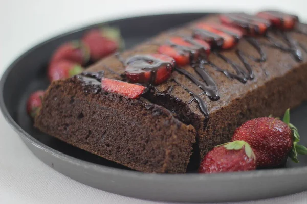 Finger millet chocalate cake. A Healthy Homemade Chocolate cake made with finger millet flour instead of all purpose flour, decorated with a generous drizzle of chocolate sauce and strawberries.