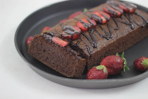 Finger millet chocalate cake. A Healthy Homemade Chocolate cake made with finger millet flour instead of all purpose flour, decorated with a generous drizzle of chocolate sauce and strawberries.