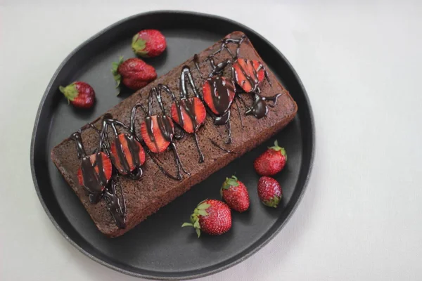 Finger millet chocalate cake. A Healthy Homemade Chocolate cake made with finger millet flour instead of all purpose flour, decorated with a generous drizzle of chocolate sauce and strawberries.