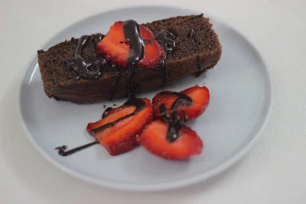 Finger millet chocalate cake. A Healthy Homemade Chocolate cake made with finger millet flour instead of all purpose flour, decorated with a generous drizzle of chocolate sauce and strawberries.