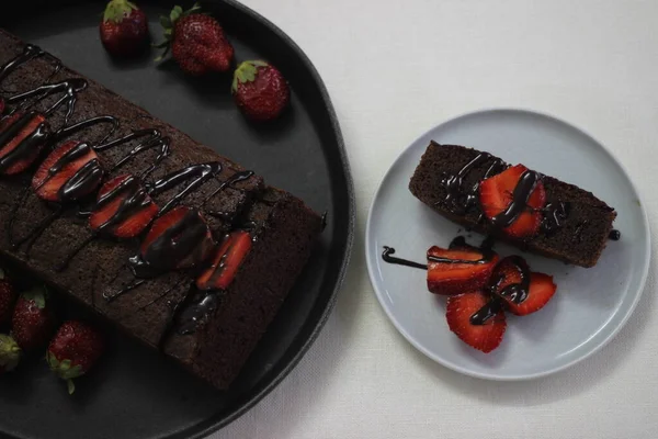 Finger millet chocalate cake. A Healthy Homemade Chocolate cake made with finger millet flour instead of all purpose flour, decorated with a generous drizzle of chocolate sauce and strawberries.