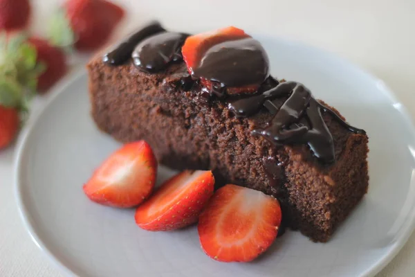 Finger millet chocalate cake. A Healthy Homemade Chocolate cake made with finger millet flour instead of all purpose flour, decorated with a generous drizzle of chocolate sauce and strawberries.