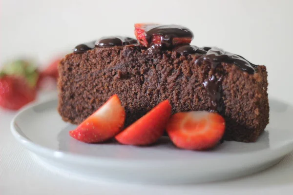 Finger millet chocalate cake. A Healthy Homemade Chocolate cake made with finger millet flour instead of all purpose flour, decorated with a generous drizzle of chocolate sauce and strawberries.