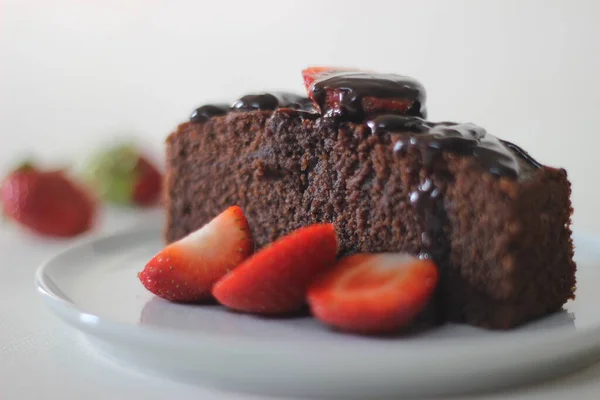 Finger millet chocalate cake. A Healthy Homemade Chocolate cake made with finger millet flour instead of all purpose flour, decorated with a generous drizzle of chocolate sauce and strawberries.