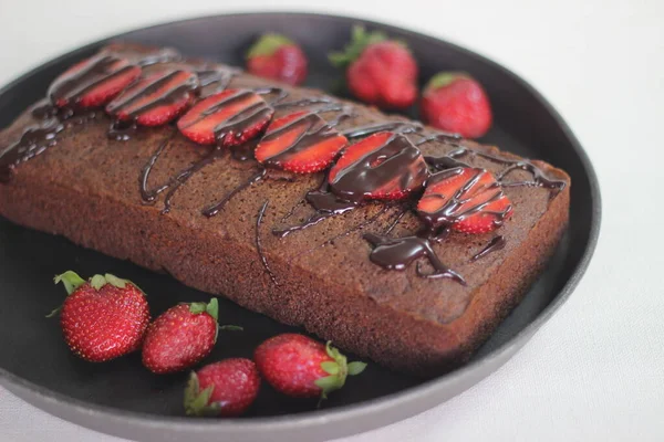 Finger millet chocalate cake. A Healthy Homemade Chocolate cake made with finger millet flour instead of all purpose flour, decorated with a generous drizzle of chocolate sauce and strawberries.