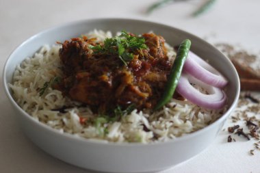 Jeera pilavı ve kızarmış tavuk. Basit ve lezzetli bir tencere pirinç hazırlama, temel malzemelerle. beyaz arkaplanda çekim