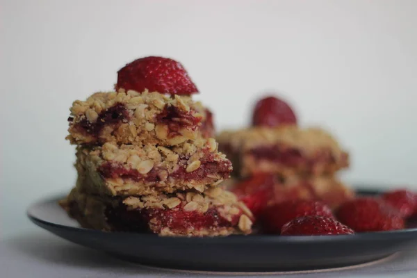 Homemade strawberry oats bar with fresh strawberries and rolled oats. Shot on white background