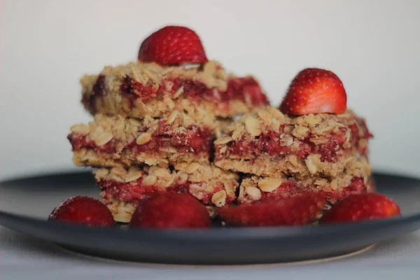 Homemade strawberry oats bar with fresh strawberries and rolled oats. Shot on white background