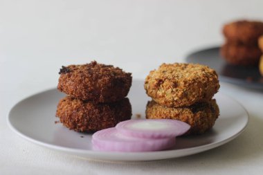 Sağ tarafta kızarmış tavuk pirzolası ve tabağın sol tarafında kızarmış tavuk pirzolası. Karşılaştırma için.