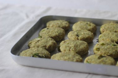 Tepside ekmek kırıntılarıyla kaplı tavuk pirzolası. Kızarmadan önce hazırlanmayı bekliyor. Beyaz arkaplanda çekilen