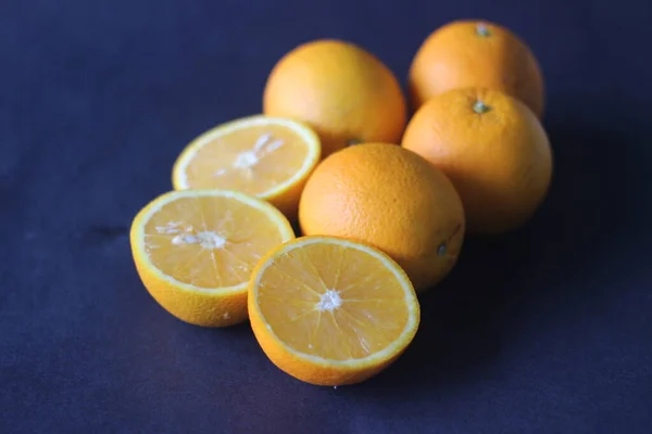 Kinnows and Sliced Kinnows which looks like Orange. It is a high yield, seedless mandarin hybrid orange like fruit cultivated extensively in the wider Punjab region of India.