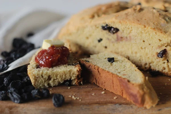 Slices of home baked Irish soda bread with raisins. A quick bread to make at home with out yeast. Served with fig jam. Shot on white background.