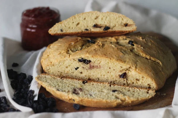 Slices of home baked Irish soda bread with raisins. A quick bread to make at home with out yeast. Served with fig jam. Shot on white background.