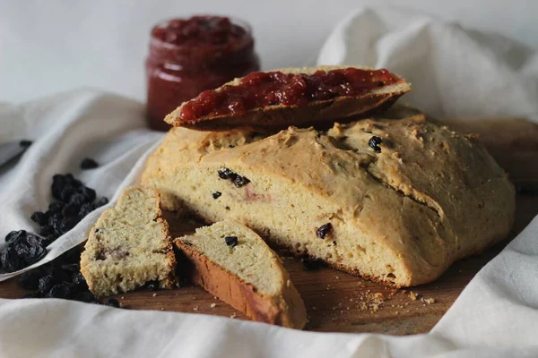 Slices of home baked Irish soda bread with raisins. A quick bread to make at home with out yeast. Served with fig jam. Shot on white background.