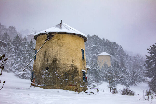 Photo of a windmill taken in a snowy landscape. Moreover, this photograph belongs to divide the turkey from the brine of the most beautiful places.