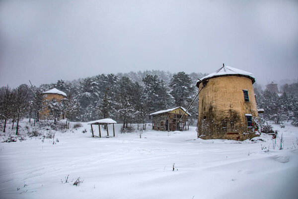 Photo of a windmill taken in a snowy landscape. Moreover, this photograph belongs to divide the turkey from the brine of the most beautiful places.