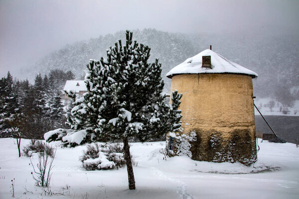 Photo of a windmill taken in a snowy landscape. Moreover, this photograph belongs to divide the turkey from the brine of the most beautiful places.