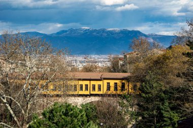 Bursa, Türkiye 'nin gerçekçi estetiğini yansıtan yüksek kalite, panoramik bir manzara. Dağların yakınındaki binalar ve santraller doğal elementlerin sansasyonunu yaratıyor..