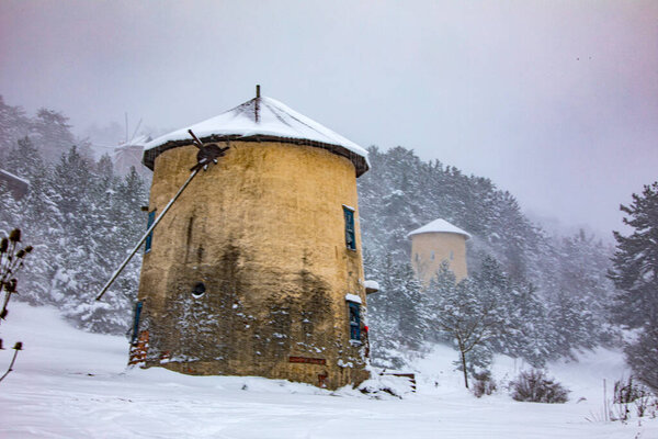 Photo of a windmill taken in a snowy landscape. Moreover, this photograph belongs to divide the turkey from the brine of the most beautiful places.
