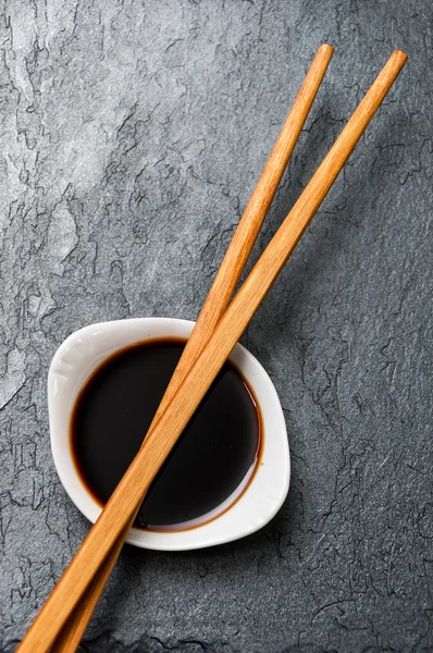 A bowl of soy sauce and chopsticks Stock Image