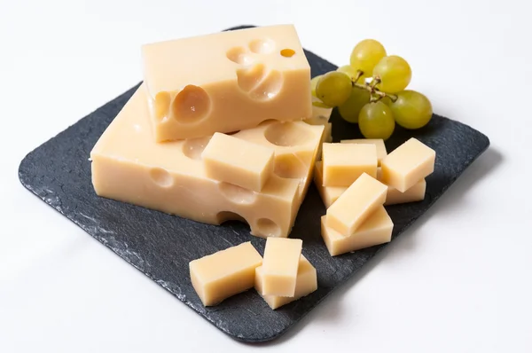 stock image Emmental cheese with grapes