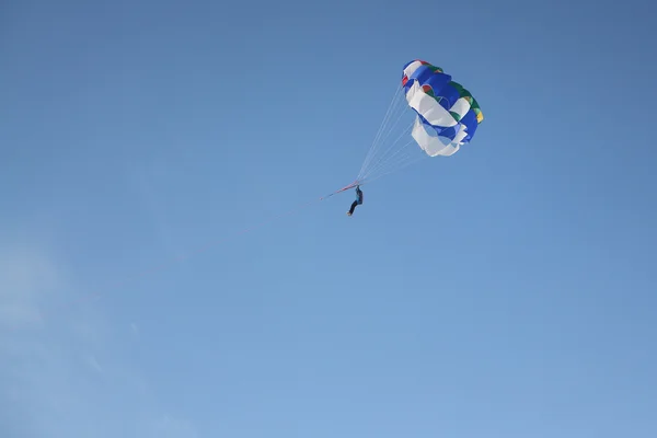 La persona con un paracaídas en un cable volando en el cielo azul —  Fotos de Stock